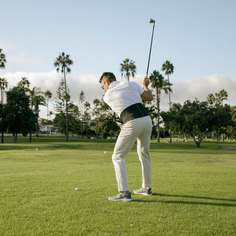 golfer wearing the X-Factor belt back support